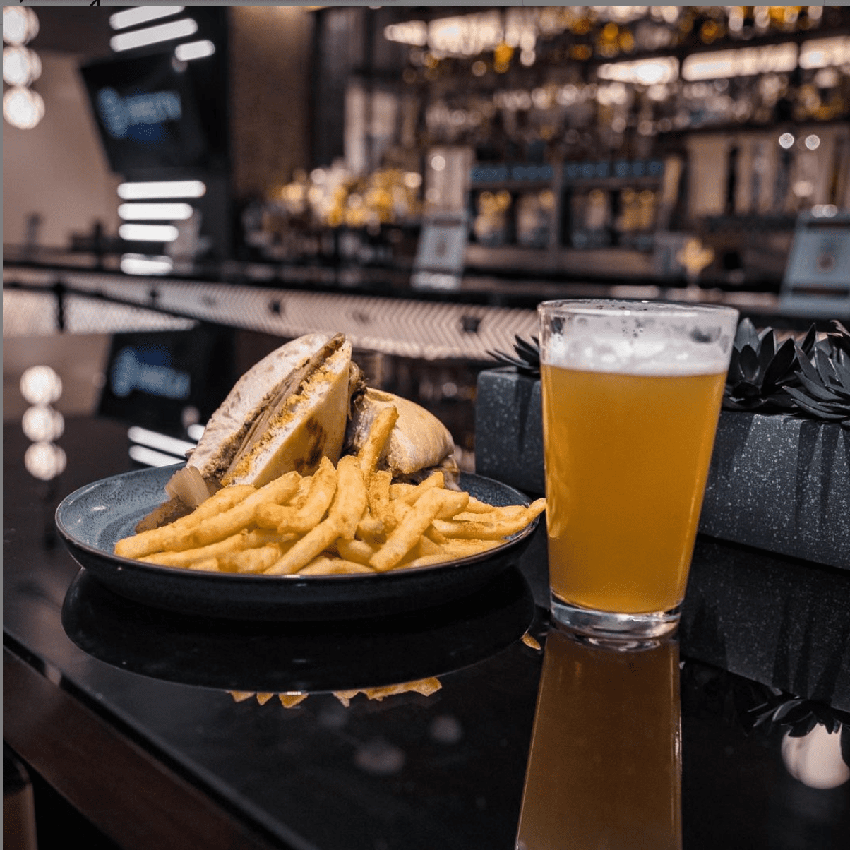 beer and a sandwich on a restaurant table